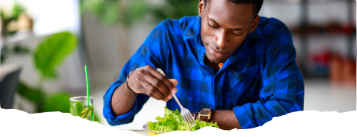 man in blue shirt sitting at a table while eating a fresh garden salad-keto-ketosis-ketogenic-keto diet-healthy recipes-free keto recipes-1